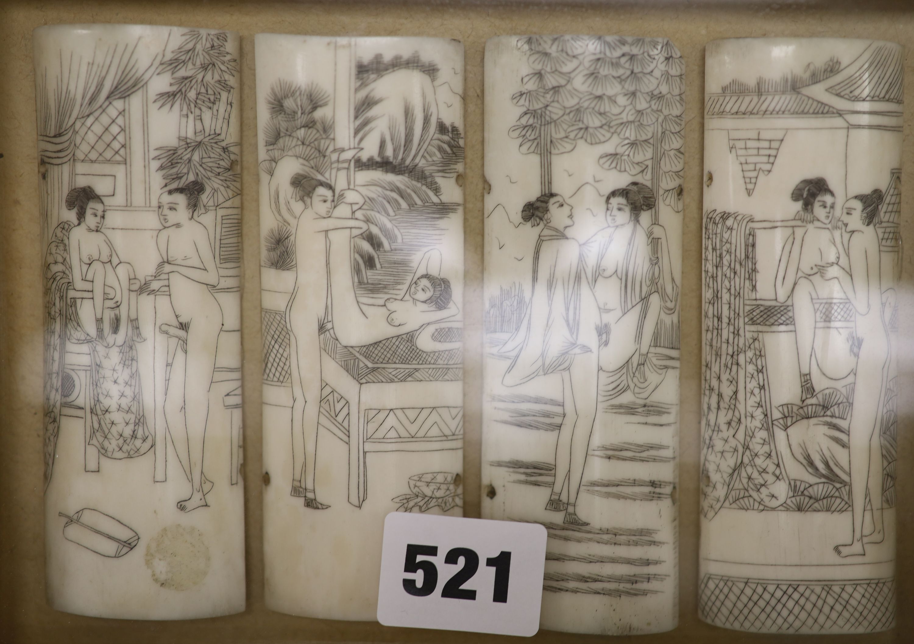 A pair of case framed cut bone panels, decorated with erotic scenes